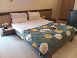 a bed in a hotel room with shoes on it at Embassy Suites in Hyderabad