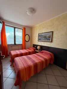 Ένα ή περισσότερα κρεβάτια σε δωμάτιο στο B&B Nonna Cecilia
