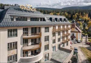 an apartment building with a pizza sign on top of it at Studio Palace 404 in Špindlerův Mlýn
