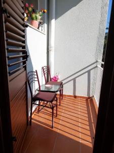 a balcony with two chairs and a table on it at Jana apartment 3 in Tivat