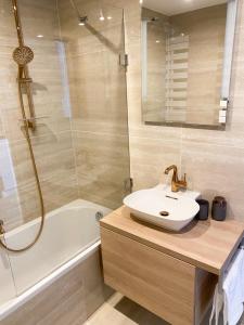 a bathroom with a sink and a shower and a tub at Studio Palace 404 in Špindlerův Mlýn