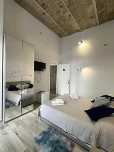 a bedroom with a large bed and a mirror at Il Tempio Pozzuoli B&B in Pozzuoli