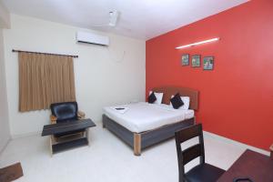 a bedroom with a bed and a desk and a chair at Happy homes services apartments -Near-Olympia Technology Park-SKCL Central Square in Chennai +24 photos
