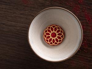 a white bowl with a red object in it at Hotel Arctic in Ilulissat