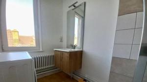a bathroom with a sink and a mirror at Le sillage de Balthus in Autun