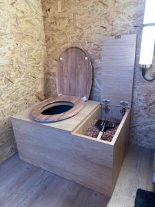 baño con aseo de madera y asiento de madera en Le dôme de Jèpo, en Ilonse