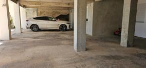 a white car parked inside of a garage at Bahr DELUX App & Suite in Ulcinj