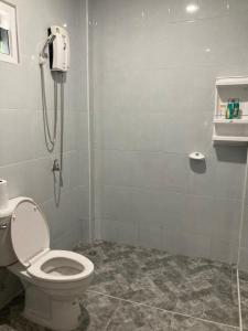 a bathroom with a toilet and a shower at Grey Garden in Thong Sala +12 photos