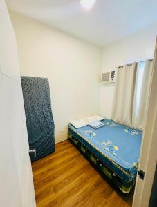 a small room with a bed in a room at Diamond Heights Azalea Davao in Davao City