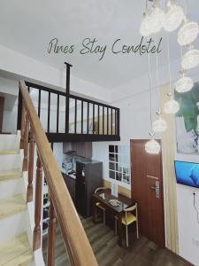 a living room with a staircase and a kitchen at Pines Stay Condotel Megatower 4 Reception in Baguio