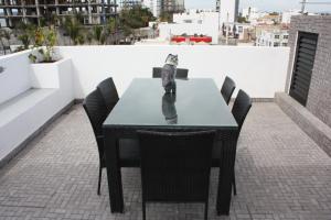 a black table and chairs on a roof at 2br 1ba Condo 1 block to ocean Condo 1 in Mazatlán