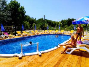 a couple of people sitting in a swimming pool at Bahr DELUX App & Suite in Ulcinj