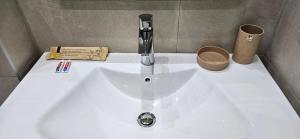 a white sink with a faucet on top of it at Bahr DELUX App & Suite in Ulcinj