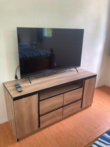 a flat screen tv sitting on top of a wooden entertainment center at Grey Garden in Thong Sala
