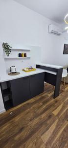 a black and white desk in a room with a wooden floor at Bahr DELUX App & Suite in Ulcinj