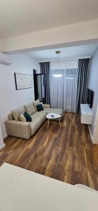 a living room with a couch and a table at Bahr DELUX App & Suite in Ulcinj