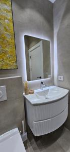a bathroom with a sink and a mirror at Bahr DELUX App & Suite in Ulcinj