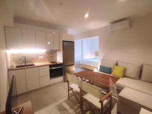 a small kitchen with a table and a bed at Kitro Parga in Parga +54 photos
