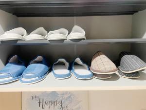 a row of shoes on a shelf with the words happy new year at Kasukabe raku house in Kasukabe