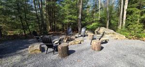 a group of chairs and logs in a forest at Recreational Therapy- Private 2 Bedroom with Hot Tub and Firepit in Oakland