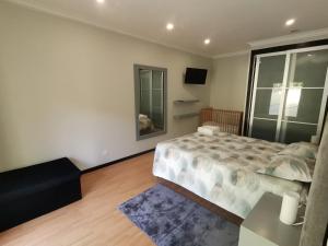 a bedroom with a bed and a table and a mirror at Casa das Marinhas in Caminha +29 photos