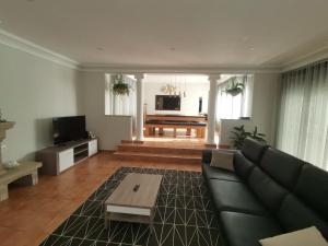 a living room with a couch and a table at Casa das Marinhas in Caminha
