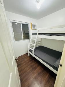 a room with two bunk beds and a window at Diamond Heights Bluebell Davao in Davao City +26 photos