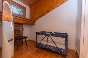 a room with a surfboard in the corner of a room at Casa Fagher in Canale dʼAgordo