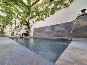 a swimming pool with a water fountain at BHost - Palace in Córdoba +40 photos
