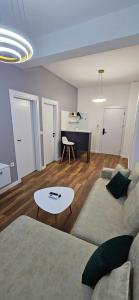 a living room with a couch and a table at Bahr DELUX App & Suite in Ulcinj