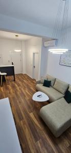 a living room with a couch and a table and a piano at Bahr DELUX App & Suite in Ulcinj