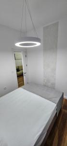 a bedroom with a large white bed in a room at Bahr DELUX App & Suite in Ulcinj