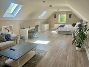 a bedroom with a bed and a desk in a room at Alpaca Lodge on the North Coast in Coleraine
