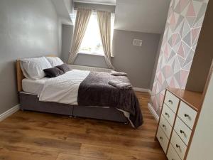 a small bedroom with a bed and a window at Serene Home in Ennis