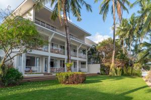 an exterior view of a building with palm trees at Baan Bophut Beach Hotel Samui - SHA Extra Plus in Bophut