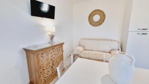 a living room with a chair and a table at Residence Maresol in Vieste
