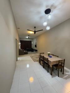 a living room with a table and a couch at Dhia Medina Homestay Jerantut in Jerantut