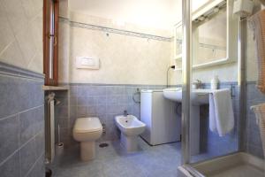 a bathroom with a toilet and a sink at Appia Antica 1BR with swimming pool in Rome +18 photos