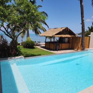 a resort with a swimming pool and a gazebo at Baan Bophut Beach Hotel Samui - SHA Extra Plus in Bophut