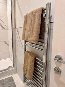 a towel rack in a bathroom with towels on it at Chic Brighton Studio in Brighton & Hove