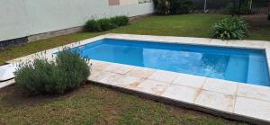 a swimming pool in the yard of a house at Hermosa Casa Con pileta y quincho in Villa Nueva