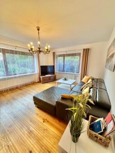a living room with a couch and a table at Ferienwohnung im Erdgeschoss mit eingezäunten Garten und Terrasse in Aurich