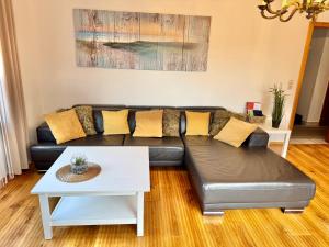a living room with a couch and a table at Ferienwohnung im Erdgeschoss mit eingezäunten Garten und Terrasse in Aurich +34 photos