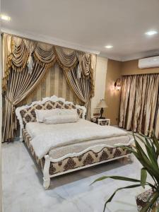 a large bedroom with a large bed with curtains at Luxurious 3BR Tropicana Residence in Batam Center