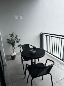 a table and two chairs on a balcony with a table and chairs at Waterfall Luxury Apartment in Midrand +1 photo