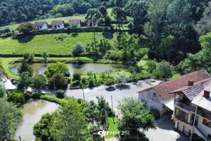 an aerial view of a house with a pond at Pousada Verde Paraíso in Nova Petrópolis