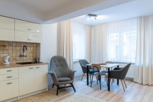 a kitchen and dining room with a table and chairs at Willa Bliźniak - Pokoje i Apartamenty Bardzo Blisko Plaży in Karwia