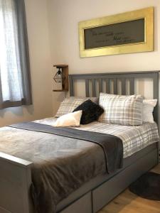 a bed with two pillows and a picture on the wall at Romantik 2-6P in Mürlenbach