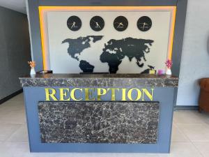 a sign for a reception with a map of the world at Cim Pansiyon Konaklama in Antalya