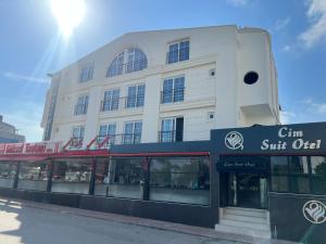 a white building with a sign in front of it at Cim Pansiyon Konaklama in Antalya